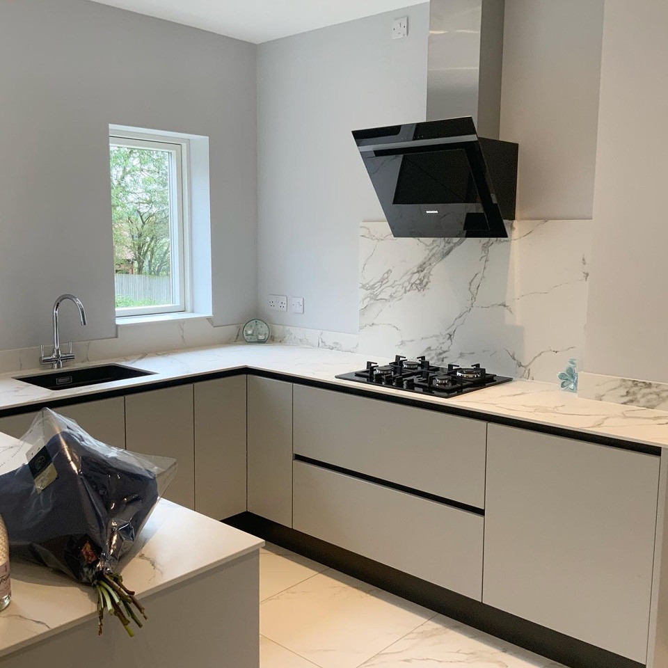 Large u-shaped kitchen in Buckinghamshire with flat-panel cabinets and grey cabinets.