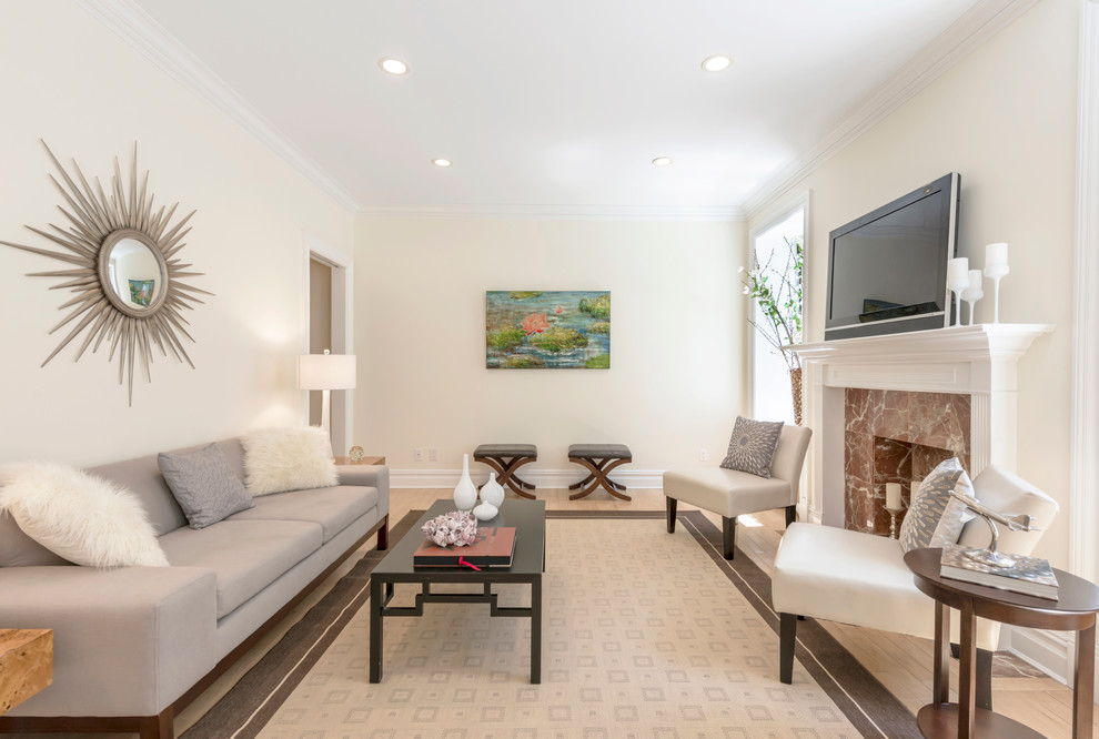 Inspiration for a mid-sized transitional light wood floor living room remodel in New York with beige walls, a standard fireplace, a stone fireplace and a tv stand