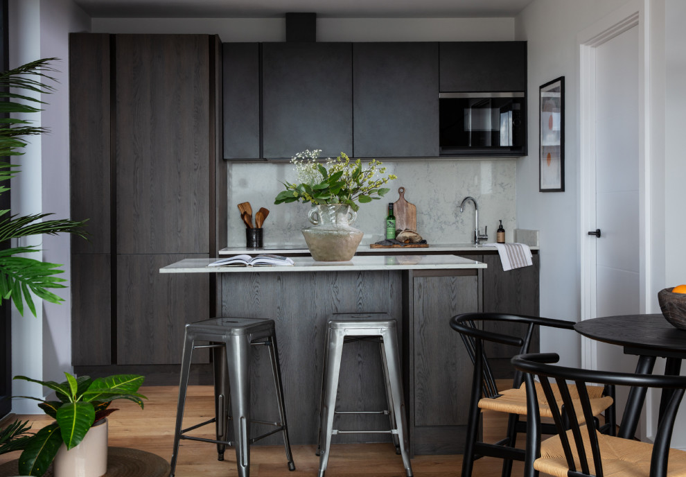 Foto di una piccola cucina contemporanea con ante lisce, ante marroni, top in quarzite, paraspruzzi bianco e pavimento in legno massello medio