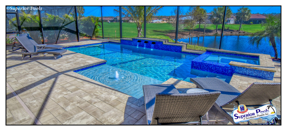Inspiration for a mid-sized contemporary backyard rectangular lap pool in Tampa with a pool house and brick pavers.