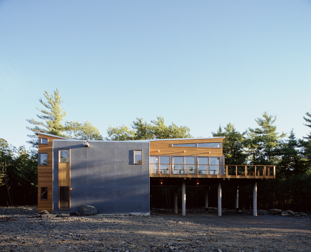Modern exterior in New York with wood siding and a butterfly roof.
