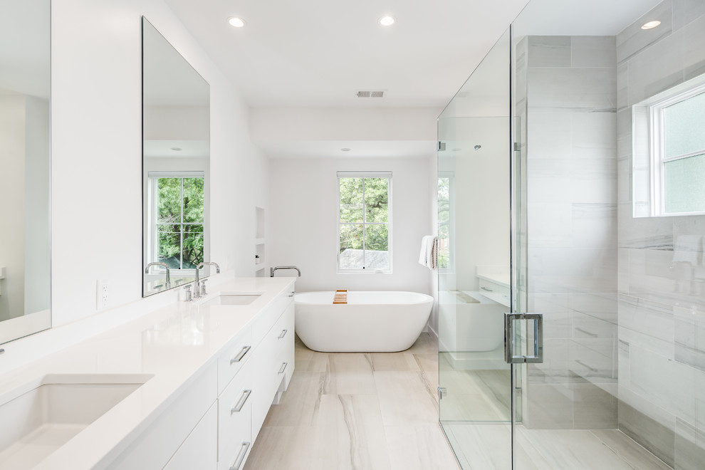 Design ideas for a large modern master bathroom in DC Metro with flat-panel cabinets, white cabinets, a freestanding tub, an alcove shower, white walls, light hardwood floors, an undermount sink, quartzite benchtops, beige floor and a hinged shower door.