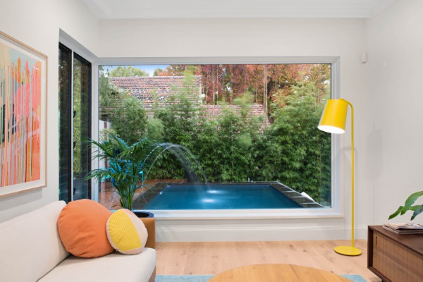 Inspiration for a small modern courtyard custom-shaped natural pool in Melbourne with a water feature and decking.