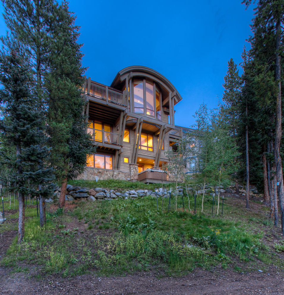 This is an example of a country three-storey exterior in Denver with wood siding.