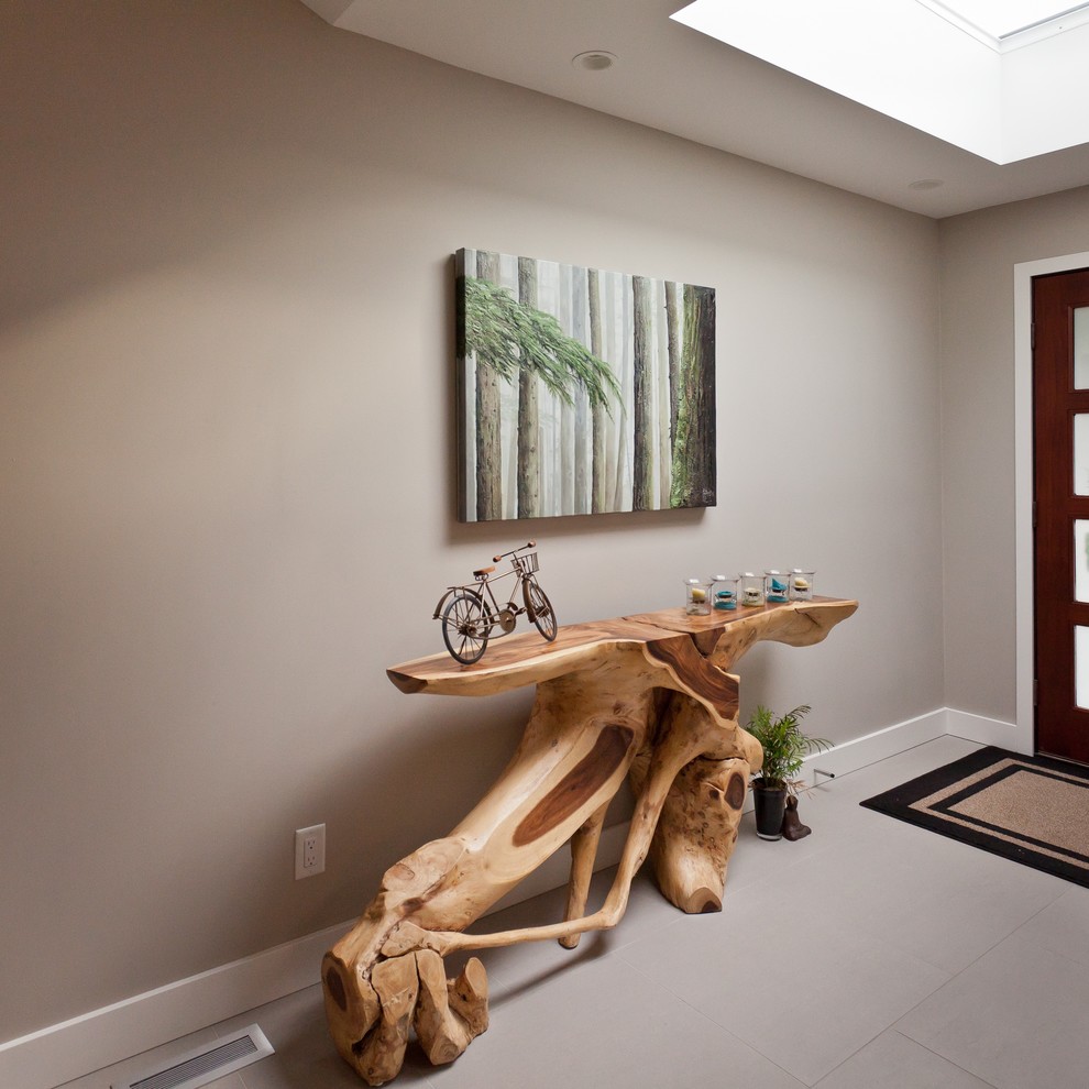 Large contemporary entry hall in Vancouver with grey walls, ceramic floors, a single front door and a dark wood front door.