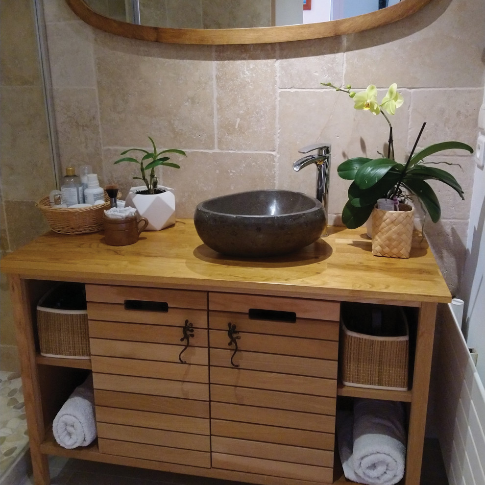 Inspiration for a small world-inspired cloakroom in Bordeaux with beige tiles, travertine tiles, beige walls, wood-effect flooring, a vessel sink, wooden worktops, grey floors, brown worktops and a freestanding vanity unit.