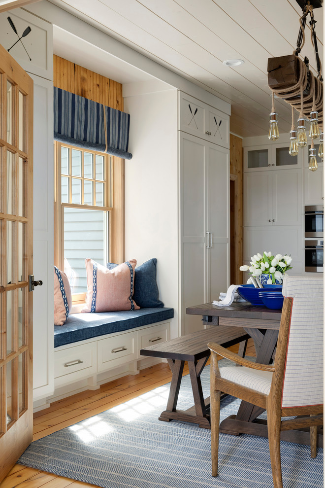 Kitchen/dining room combo - small coastal medium tone wood floor, brown floor, shiplap ceiling and shiplap wall kitchen/dining room combo idea in Minneapolis with no fireplace and white walls