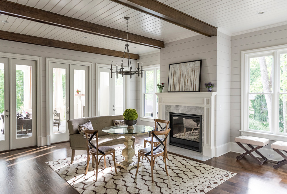 Design ideas for a country dining room in Atlanta with dark hardwood floors, a standard fireplace and a stone fireplace surround.