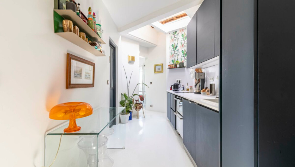 Mid-sized contemporary single-wall open plan kitchen in Other with a single-bowl sink, flat-panel cabinets, blue cabinets, solid surface benchtops, white splashback, stainless steel appliances, concrete floors, multiple islands, white floor and white benchtop.