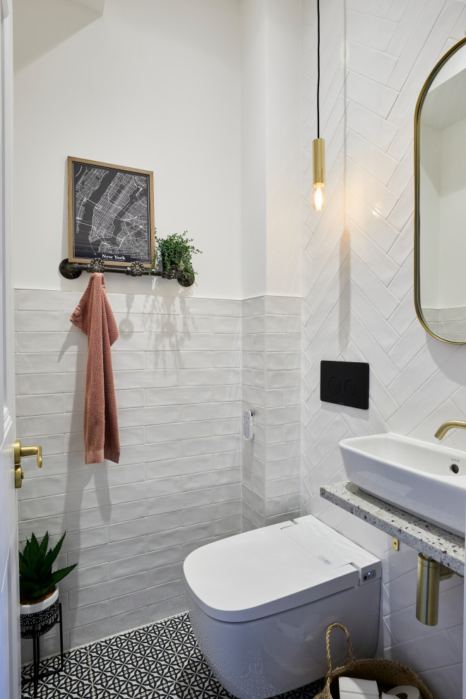 Inspiration for a small transitional bathroom in London with a wall-mount toilet, white tile, white walls, a vessel sink, terrazzo benchtops, multi-coloured floor, grey benchtops and a floating vanity.