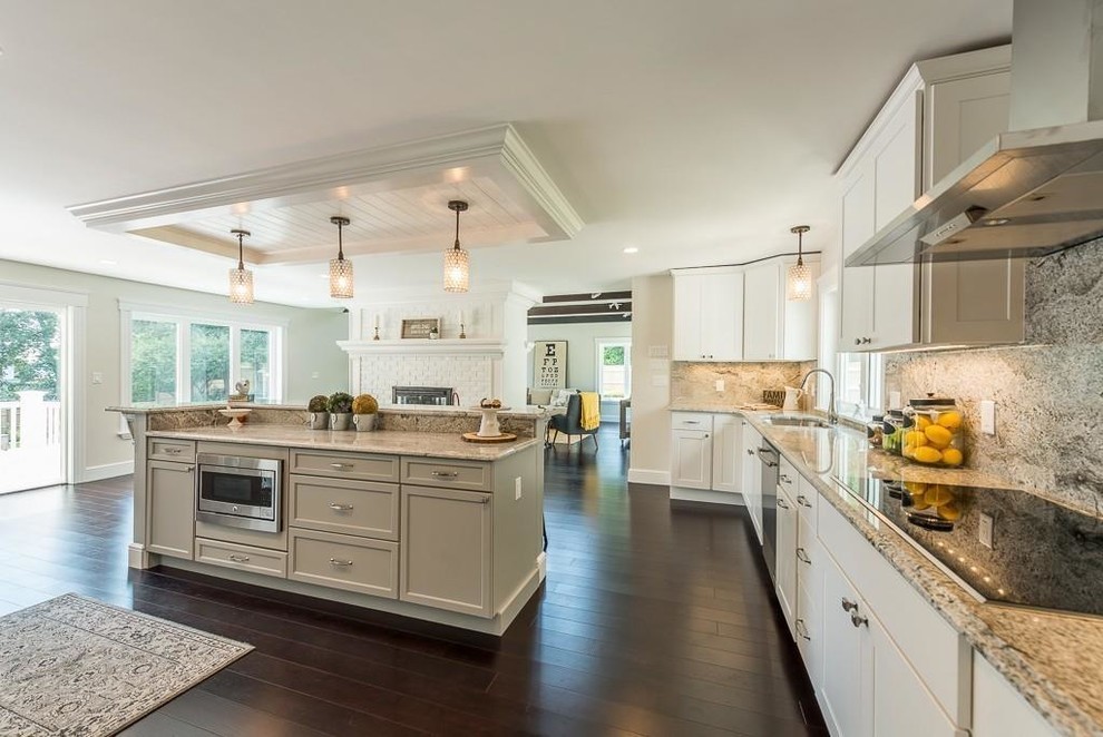 Inspiration for a large transitional u-shaped open plan kitchen in Boston with an undermount sink, shaker cabinets, white cabinets, granite benchtops, grey splashback, stone slab splashback, stainless steel appliances, bamboo floors, with island, brown floor and grey benchtop.
