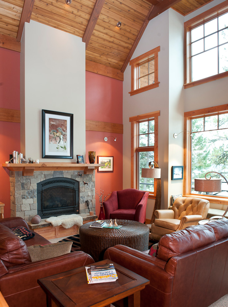 Photo of a mid-sized arts and crafts open concept living room in Other with red walls, carpet, a standard fireplace, a stone fireplace surround, no tv and grey floor.