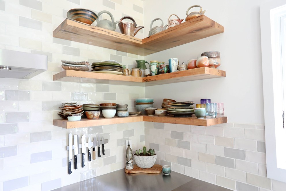 Example of a mid-sized transitional l-shaped light wood floor and beige floor open concept kitchen design with an integrated sink, shaker cabinets, blue cabinets, stainless steel countertops, ceramic backsplash, stainless steel appliances, an island and gray countertops