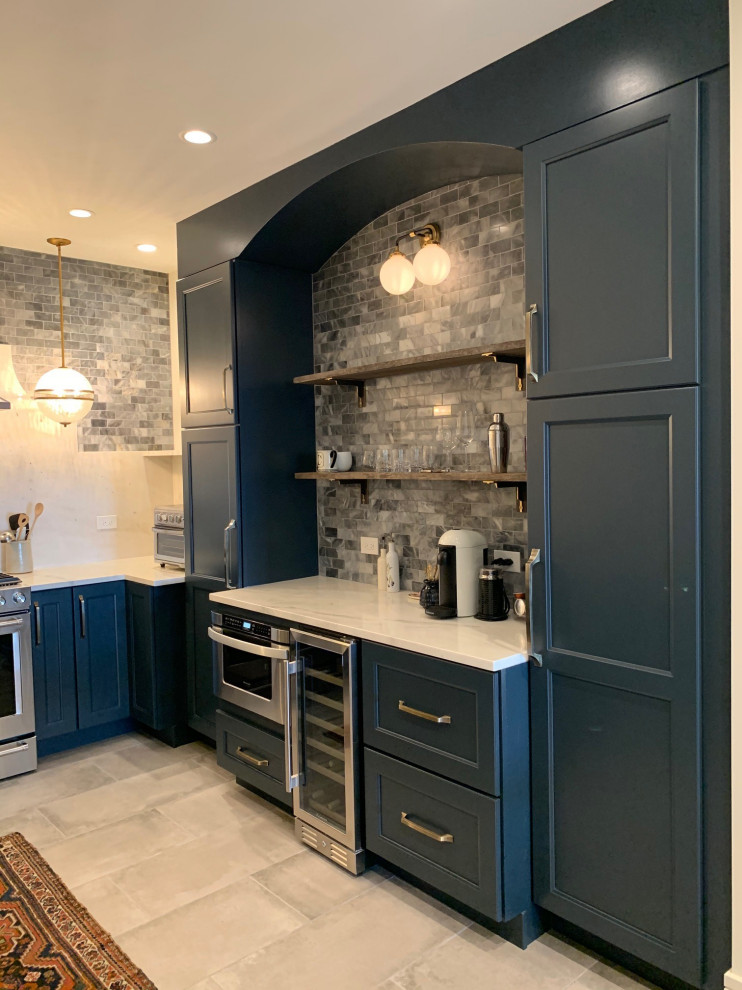 Inspiration for a small eclectic u-shaped separate kitchen in Chicago with an undermount sink, shaker cabinets, blue cabinets, quartz benchtops, white splashback, engineered quartz splashback, stainless steel appliances, grey floor and white benchtop.