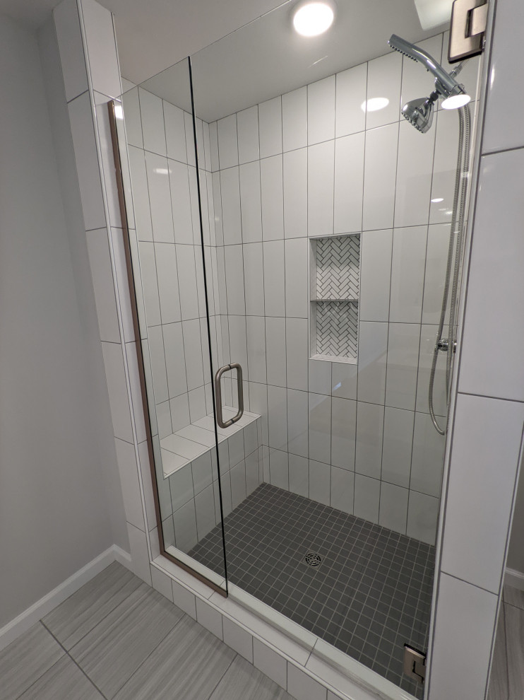 Design ideas for a large transitional master bathroom in Other with shaker cabinets, white cabinets, an open shower, white tile, porcelain tile, porcelain floors, quartzite benchtops, grey floor, a hinged shower door, a shower seat, a double vanity and a built-in vanity.