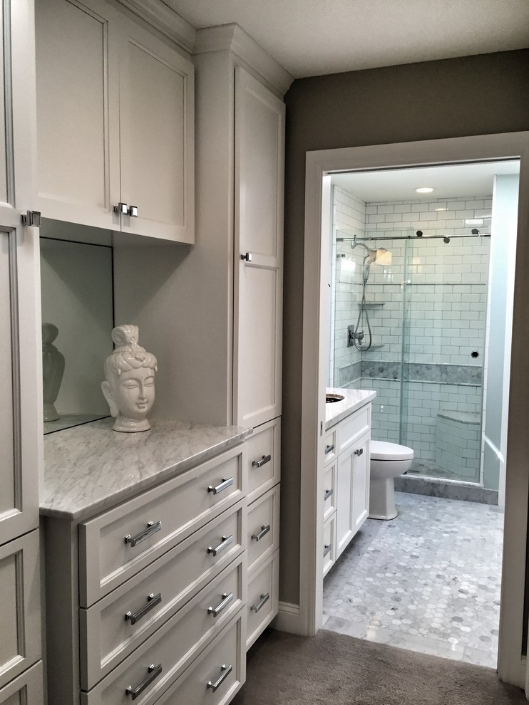 This is an example of a small transitional women's dressing room in San Francisco with shaker cabinets, white cabinets and carpet.