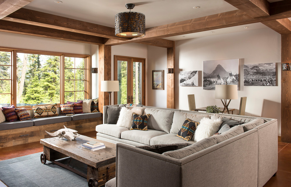 This is an example of a country open concept family room in Other with white walls and brown floor.