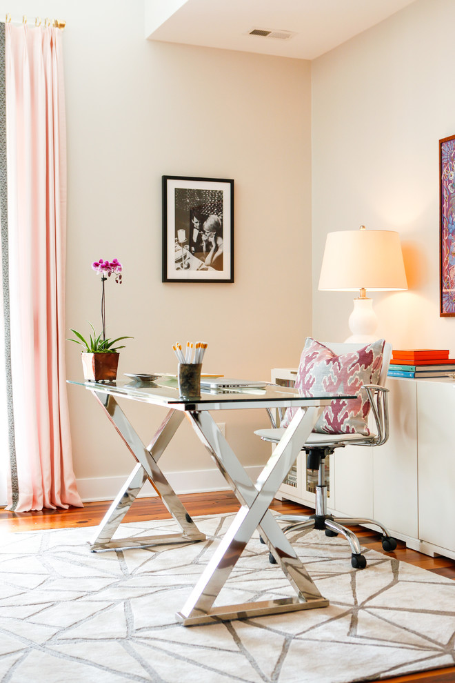 Photo of a large eclectic study room in Houston with a freestanding desk, beige walls and medium hardwood floors.