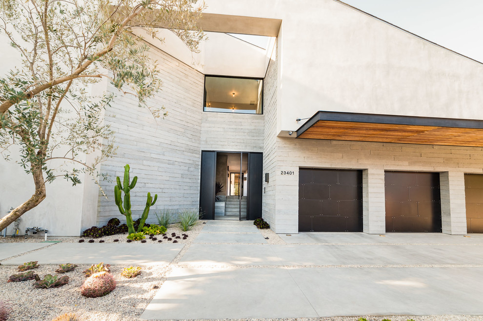 Inspiration for an expansive contemporary split-level grey house exterior in Los Angeles with mixed siding.