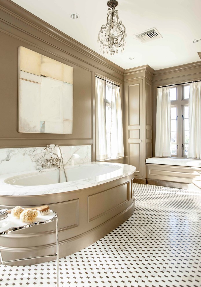 This is an example of a traditional master bathroom in Atlanta with an undermount tub, beige walls, marble floors, multi-coloured floor, white tile and stone slab.