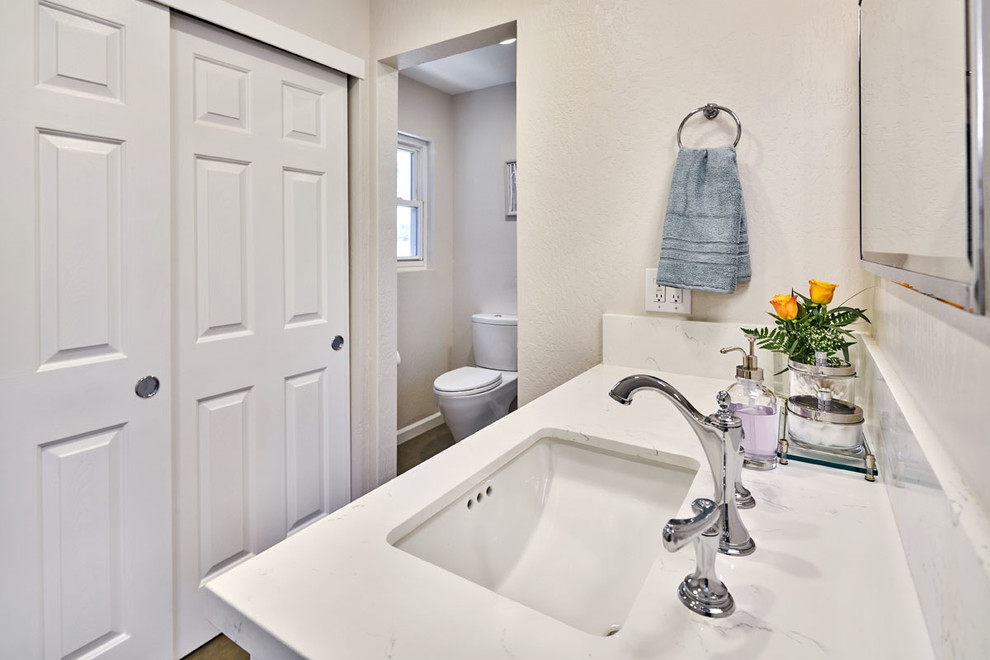 Example of a mid-sized transitional master beige tile and glass tile doorless shower design in San Francisco with shaker cabinets, white cabinets, a two-piece toilet, beige walls, an undermount sink and quartzite countertops
