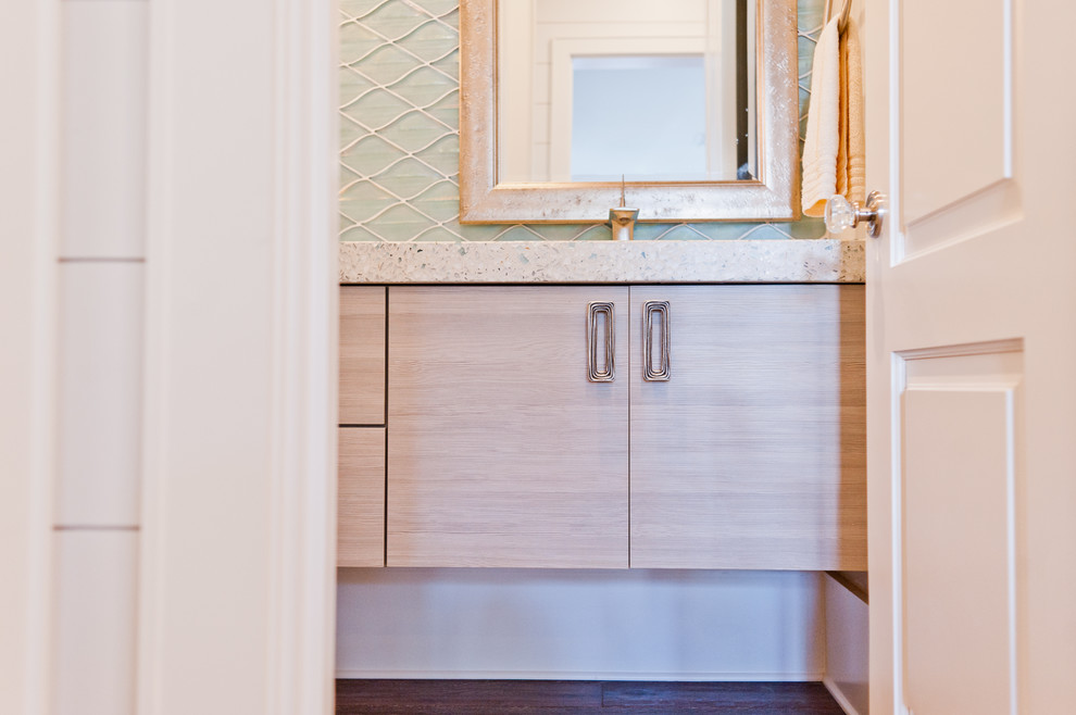 Photo of a mid-sized beach style powder room in Jacksonville with flat-panel cabinets, light wood cabinets, blue tile, glass tile, an integrated sink and terrazzo benchtops.