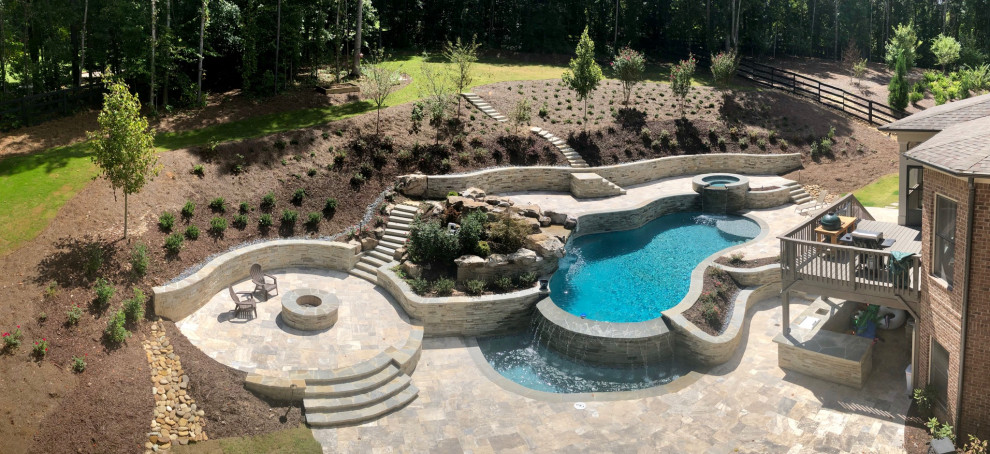 Design ideas for a large classic back custom shaped natural swimming pool in Atlanta with with pool landscaping.