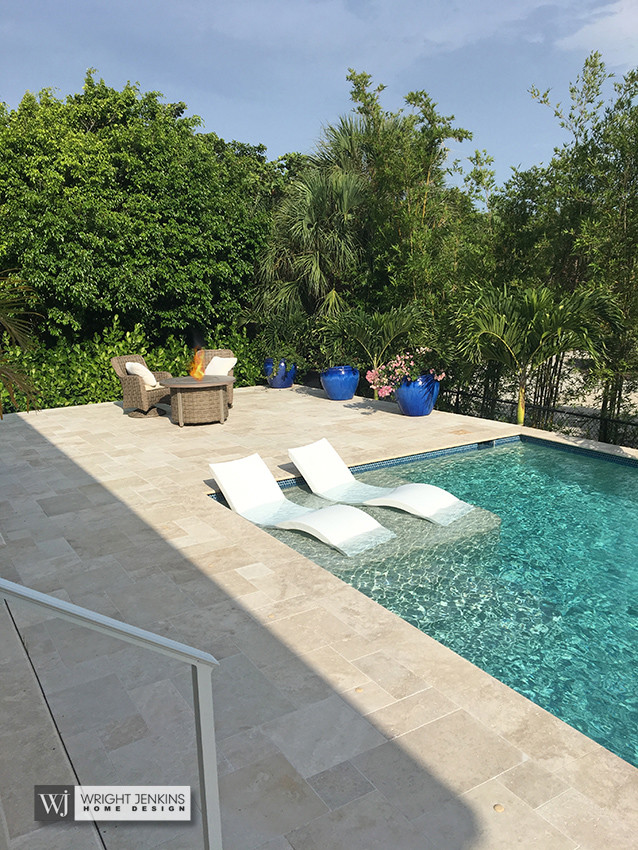Inspiration for a mid-sized beach style backyard rectangular lap pool in Tampa with a water feature and natural stone pavers.