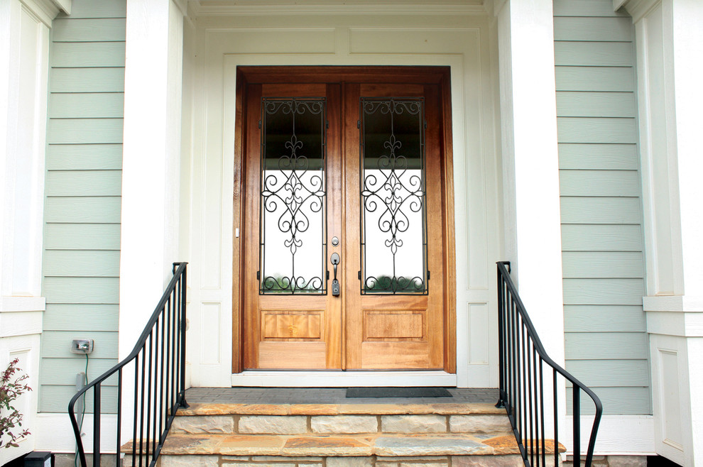Photo of a traditional front door in Raleigh with a double front door and a light wood front door.