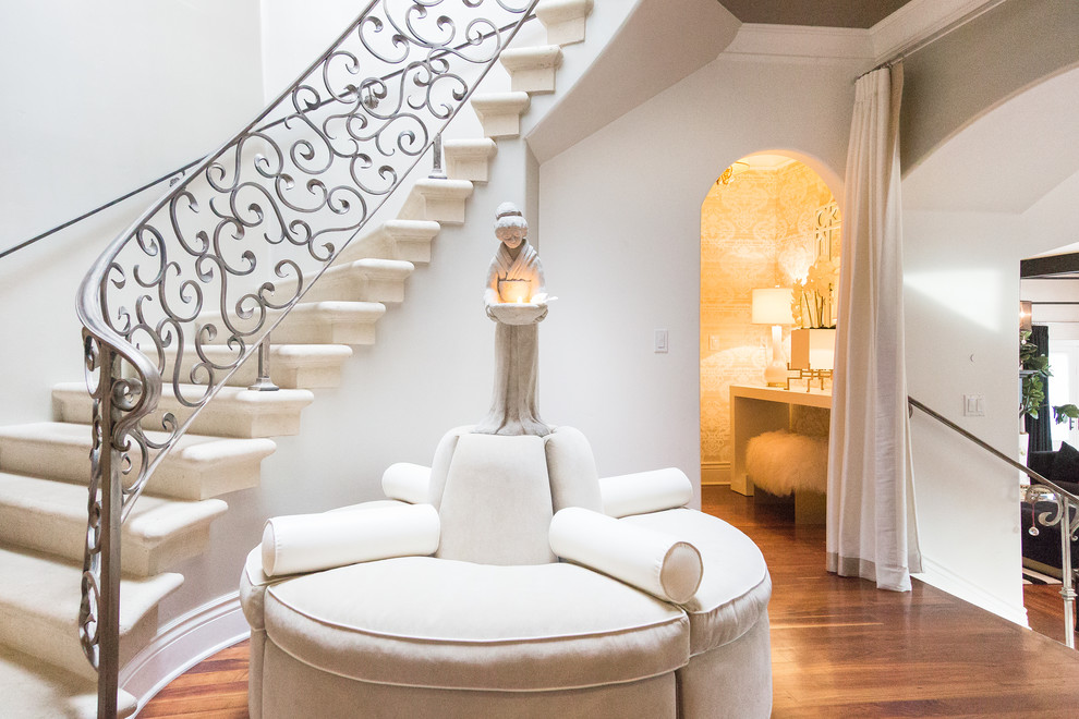 Example of a mid-sized transitional medium tone wood floor and brown floor foyer design with white walls