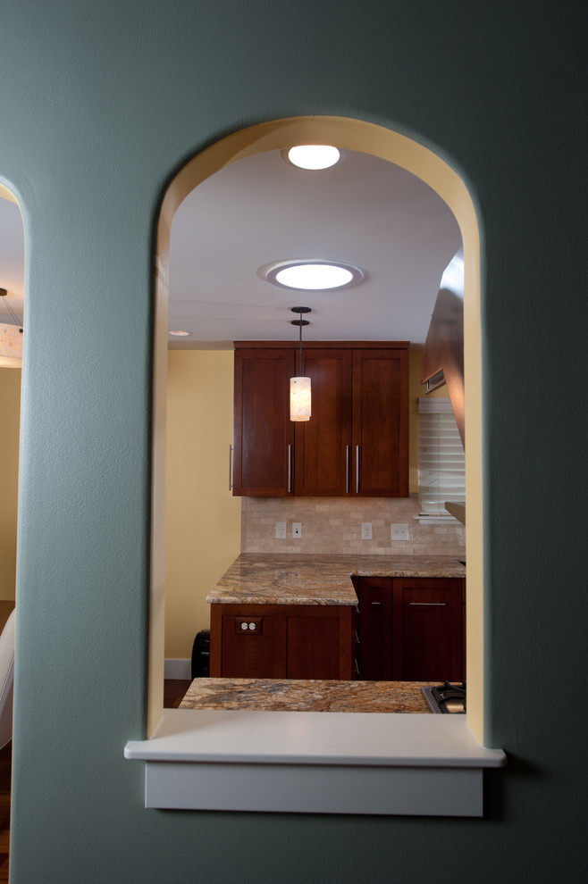 Eat-in kitchen - transitional galley medium tone wood floor eat-in kitchen idea in Austin with an undermount sink, recessed-panel cabinets, medium tone wood cabinets, granite countertops, beige backsplash, ceramic backsplash, yellow walls and no island