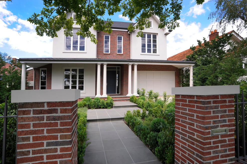 Large traditional two-storey brick white exterior in Melbourne with a clipped gable roof.