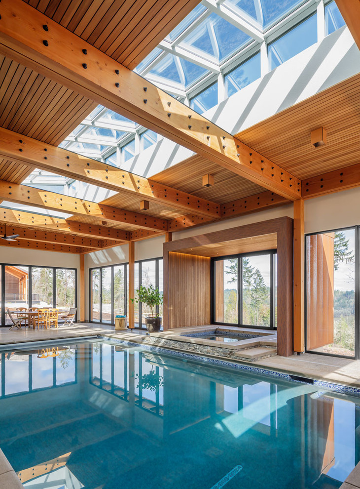 This is an example of a country indoor rectangular pool in Other with a hot tub.