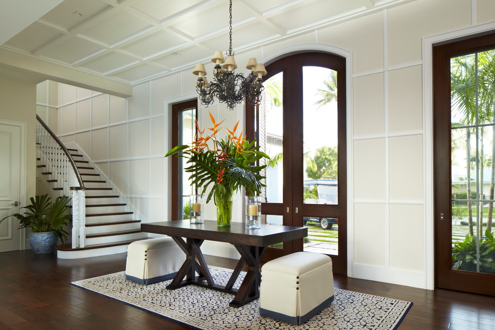 Photo of a tropical entryway in Miami with beige walls.