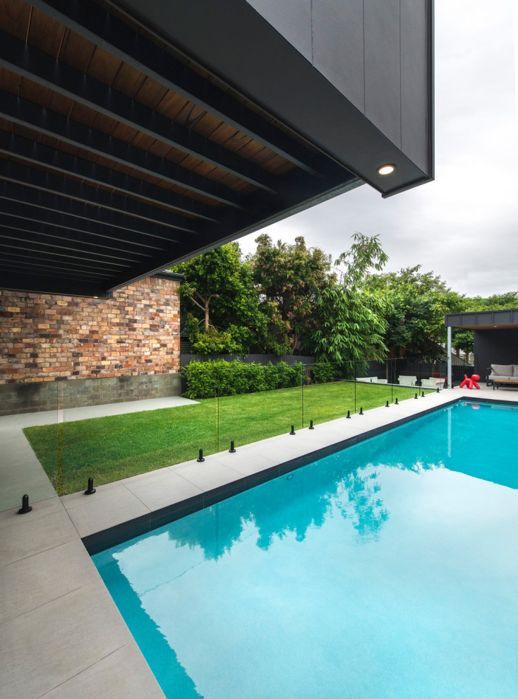 This is an example of a large contemporary backyard rectangular pool.