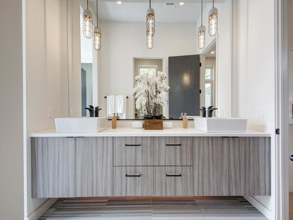 This is an example of a large modern master bathroom in Austin with flat-panel cabinets, grey cabinets, black and white tile, stone tile, marble floors, a vessel sink, quartzite benchtops, white walls, a freestanding tub and an open shower.