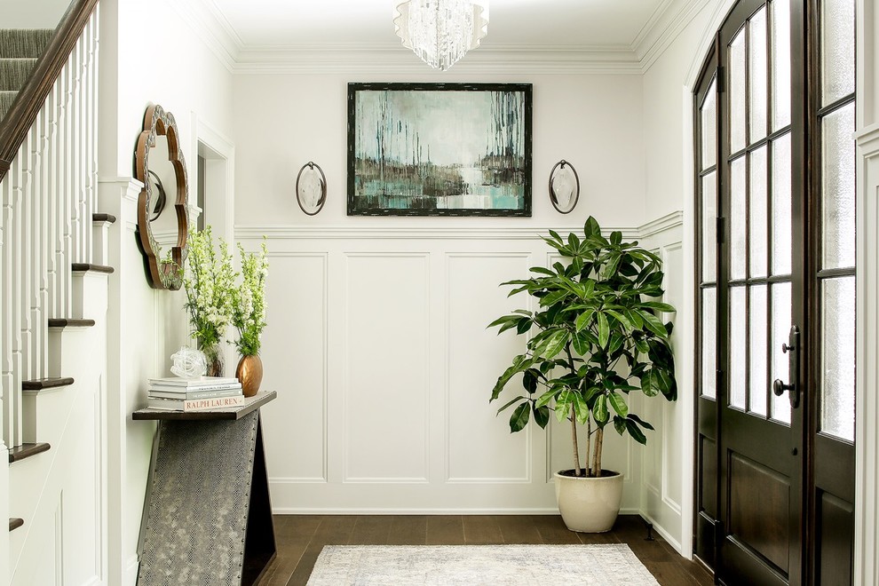 Photo of a mid-sized transitional foyer in New York with beige walls, dark hardwood floors, a single front door and a dark wood front door.