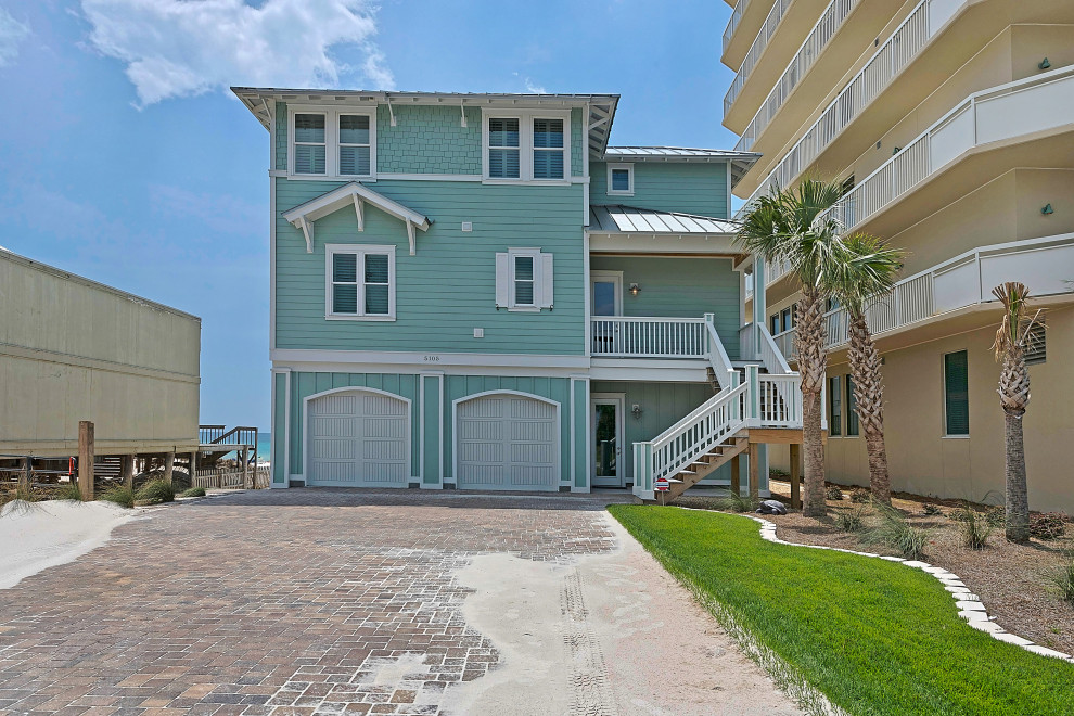 Inspiration for a huge coastal blue concrete fiberboard and clapboard house exterior remodel with a hip roof, a metal roof and a gray roof