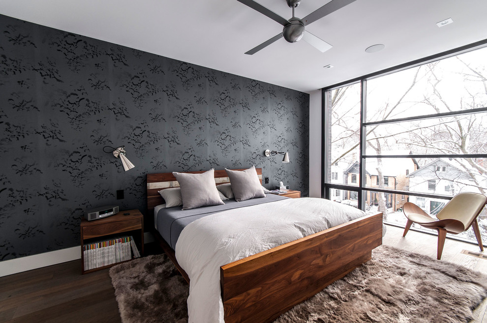 Photo of a modern master bedroom in Toronto with black walls.