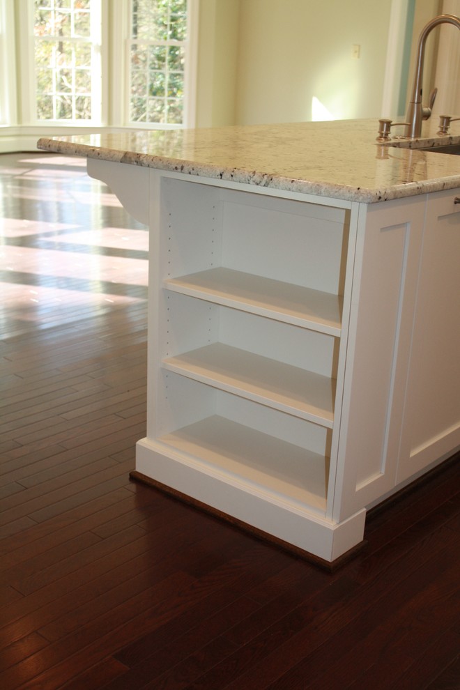 Eat-in kitchen - mid-sized transitional u-shaped dark wood floor eat-in kitchen idea in Charlotte with an undermount sink, recessed-panel cabinets, white cabinets, granite countertops, stainless steel appliances and an island