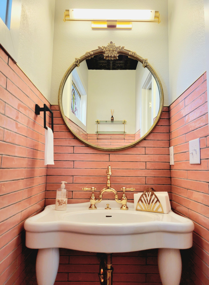 Aménagement d'un WC et toilettes victorien avec un carrelage rose, des carreaux de porcelaine, meuble-lavabo sur pied et boiseries.