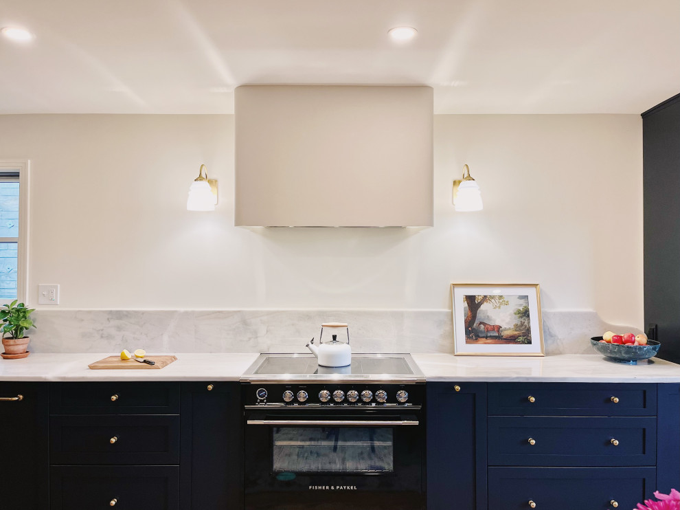 Eat-in kitchen - large transitional l-shaped medium tone wood floor and brown floor eat-in kitchen idea with an undermount sink, shaker cabinets, blue cabinets, quartzite countertops, stone slab backsplash, paneled appliances, no island and gray countertops