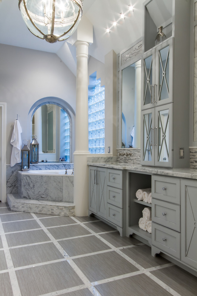 Inspiration for a contemporary bathroom in Houston with an undermount sink, furniture-like cabinets, grey cabinets, marble benchtops, a corner tub, a curbless shower, a one-piece toilet, multi-coloured tile and porcelain tile.
