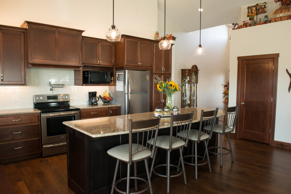 Inspiration for a large transitional l-shaped medium tone wood floor open concept kitchen remodel with an undermount sink, flat-panel cabinets, medium tone wood cabinets, quartz countertops, white backsplash, ceramic backsplash, stainless steel appliances, an island and multicolored countertops