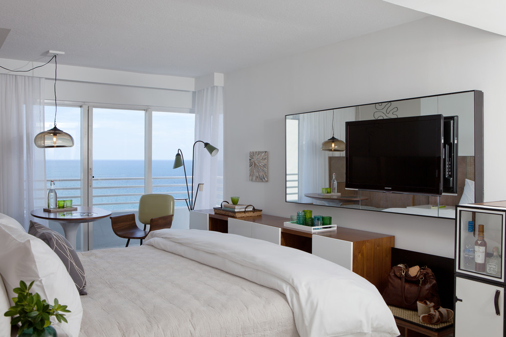 This is an example of a mid-sized contemporary guest bedroom in Miami with white walls, ceramic floors and no fireplace.
