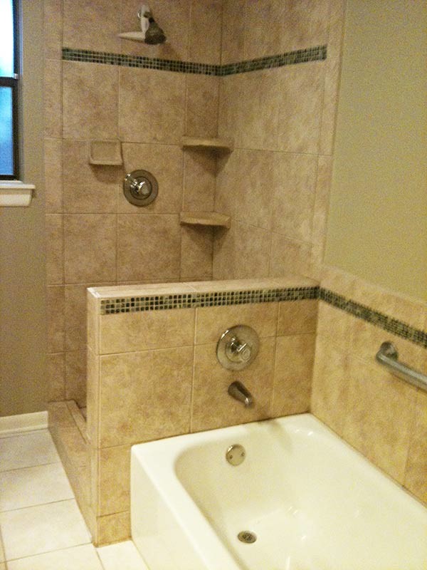 Inspiration for a transitional alcove bathtub remodel in Austin with green walls