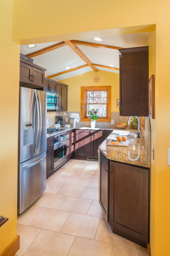 Small mountain style u-shaped porcelain tile eat-in kitchen photo in Providence with an undermount sink, shaker cabinets, dark wood cabinets, granite countertops, beige backsplash, porcelain backsplash and stainless steel appliances