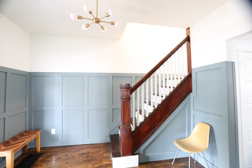 Photo of a mid-sized transitional wood straight staircase in Cincinnati with painted wood risers and wood railing.