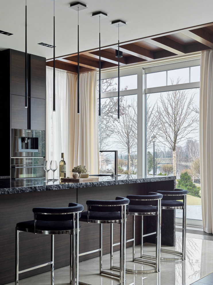 This is an example of a contemporary kitchen in Moscow with with island and black benchtop.