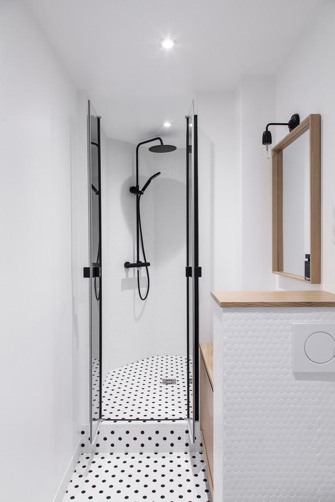 Design ideas for a contemporary bathroom in Paris with flat-panel cabinets, light wood cabinets, an alcove shower, white tile, white walls, wood benchtops, multi-coloured floor, a hinged shower door and beige benchtops.